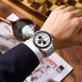 Homem usando o Relógio social masculino elegante Nibosi Nimbus com pulseira de aço inoxidável prata e visor branco 44mm e cronógrafo funcional, destacando sua elegância 
